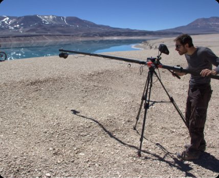 Armin Buchroithner operating a camera on a jib in a high desert landscape.